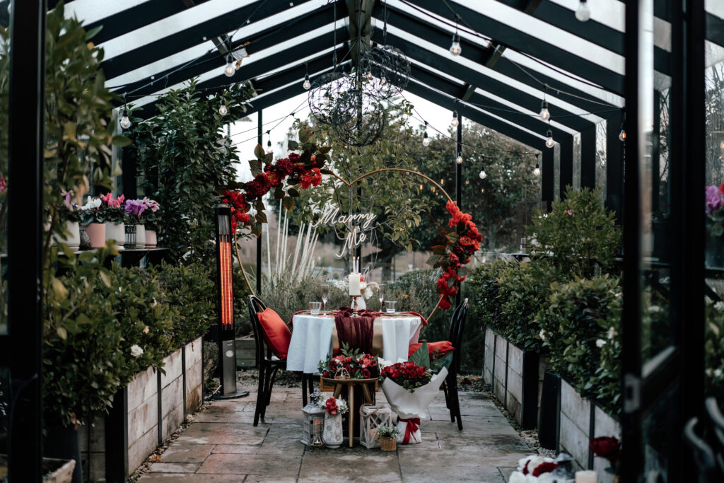 A beautiful red Marry Me set up in the Greenhouse at The Grange in Takapuna for the perfect marriage proposal.