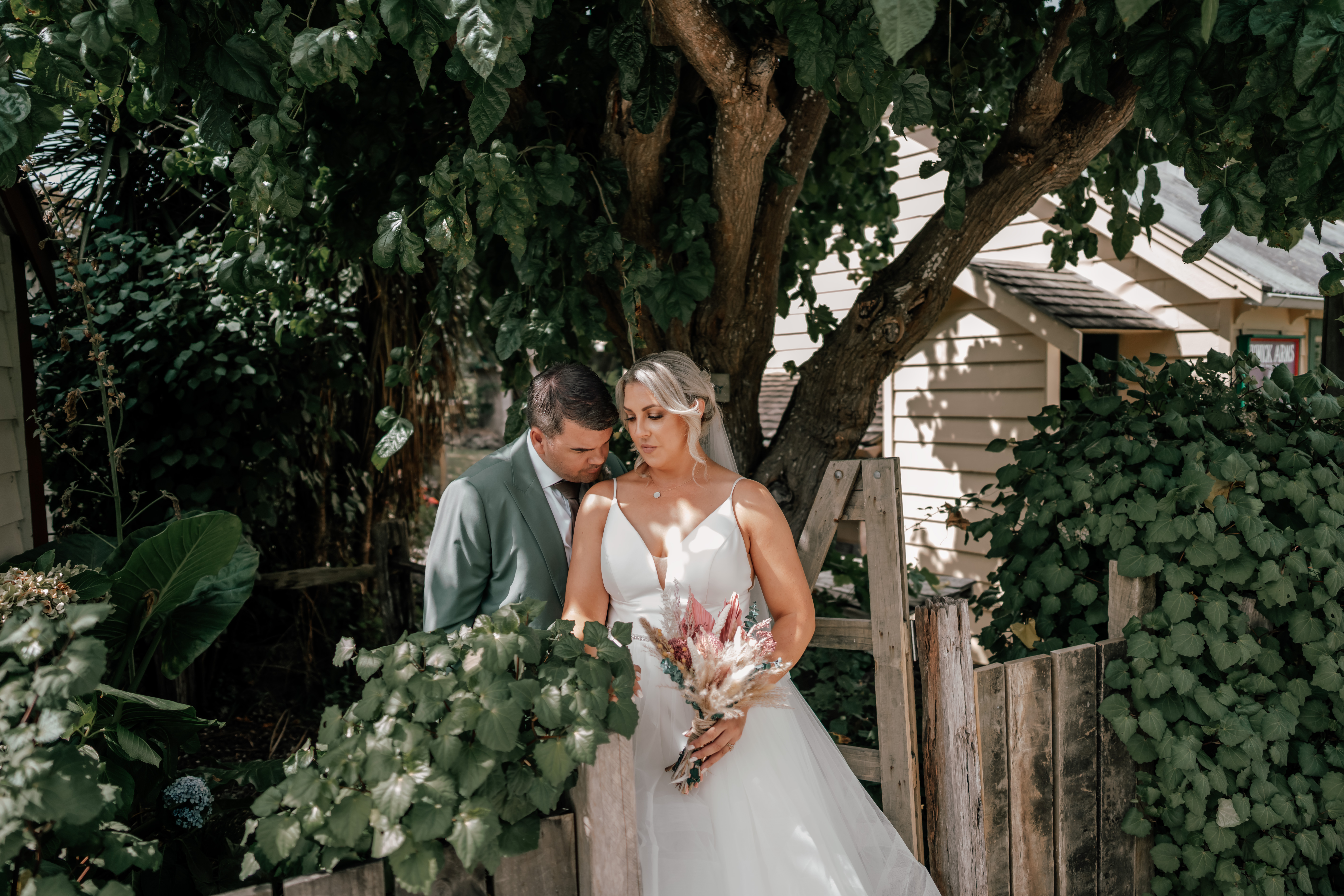 Bride and groom at Howick Historical Village chapel after emotional family sand ceremony on their wedding day