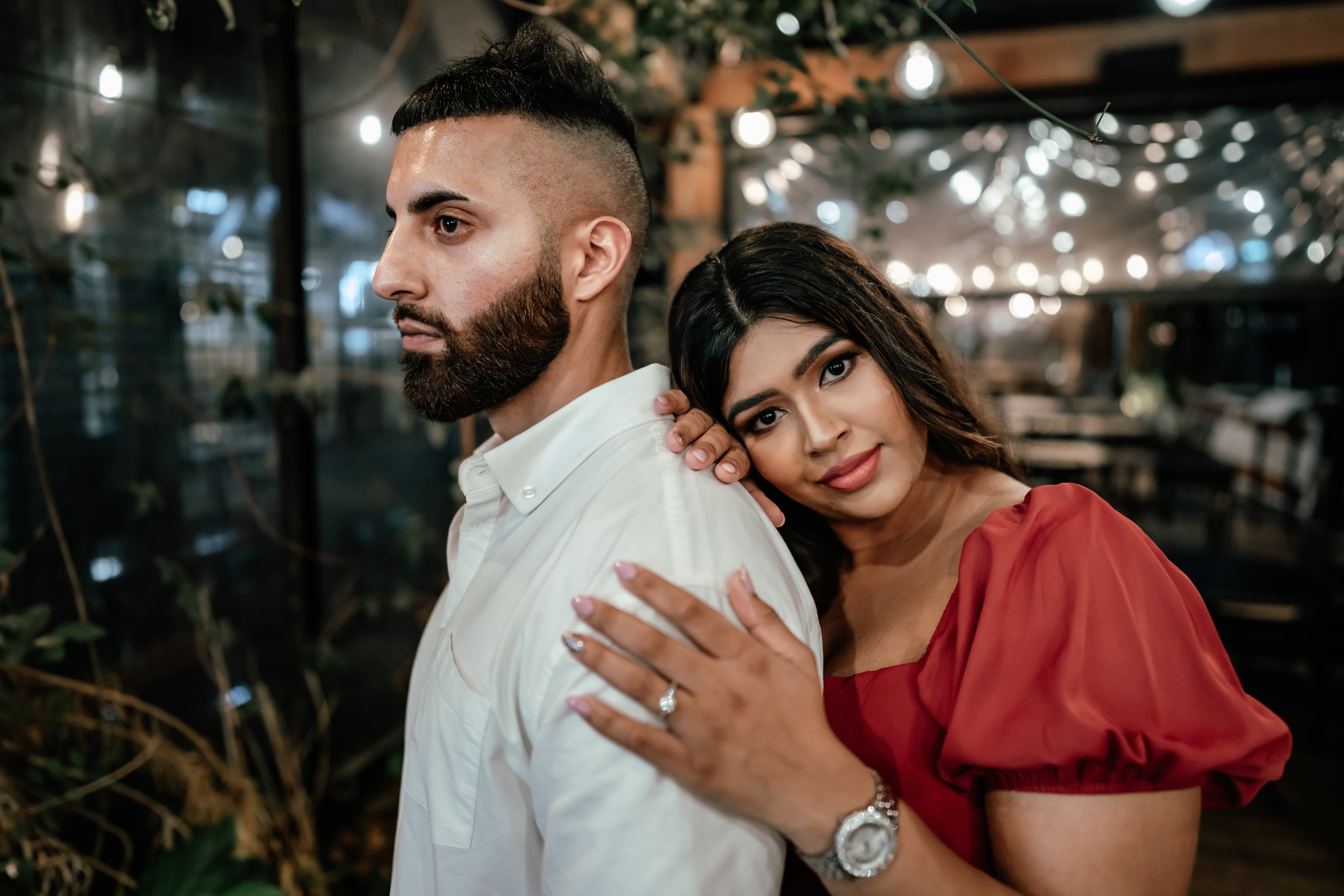 Romantic winter proposal at The Grange in Takapuna, with soft rain, warm lighting, and a stunning red dress captured by Auckland proposal photographer Zanthe Vorsatz.