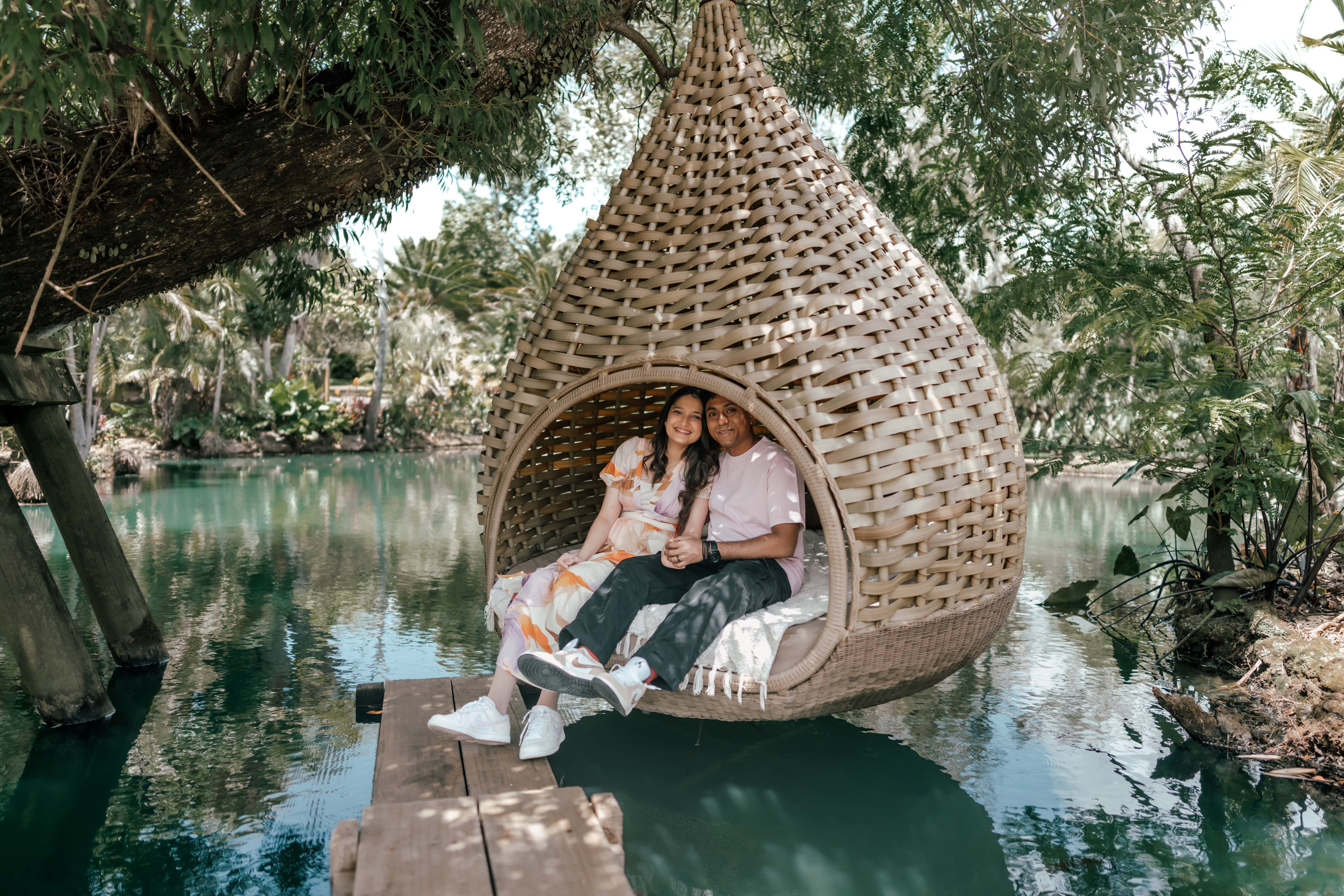 Couple sharing an emotional double proposal at Waimauku Gardens, surrounded by lush greenery and romantic garden scenery