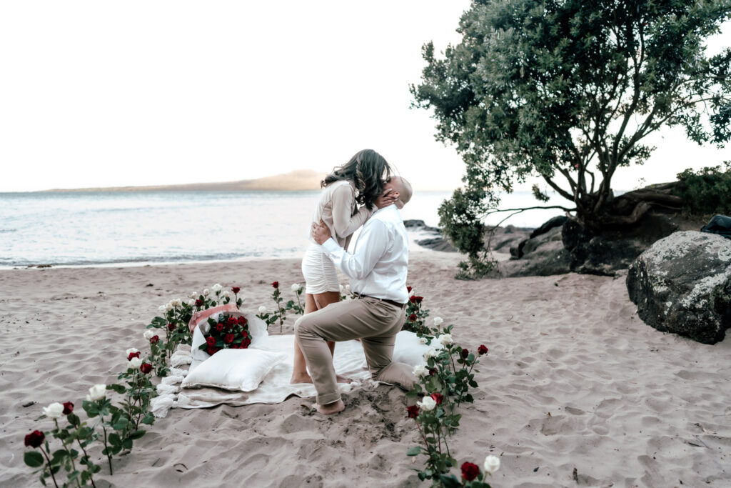 Romantic New Year’s Eve proposal on the beach at The Cove Devonport with candlelight, champagne, and ocean views