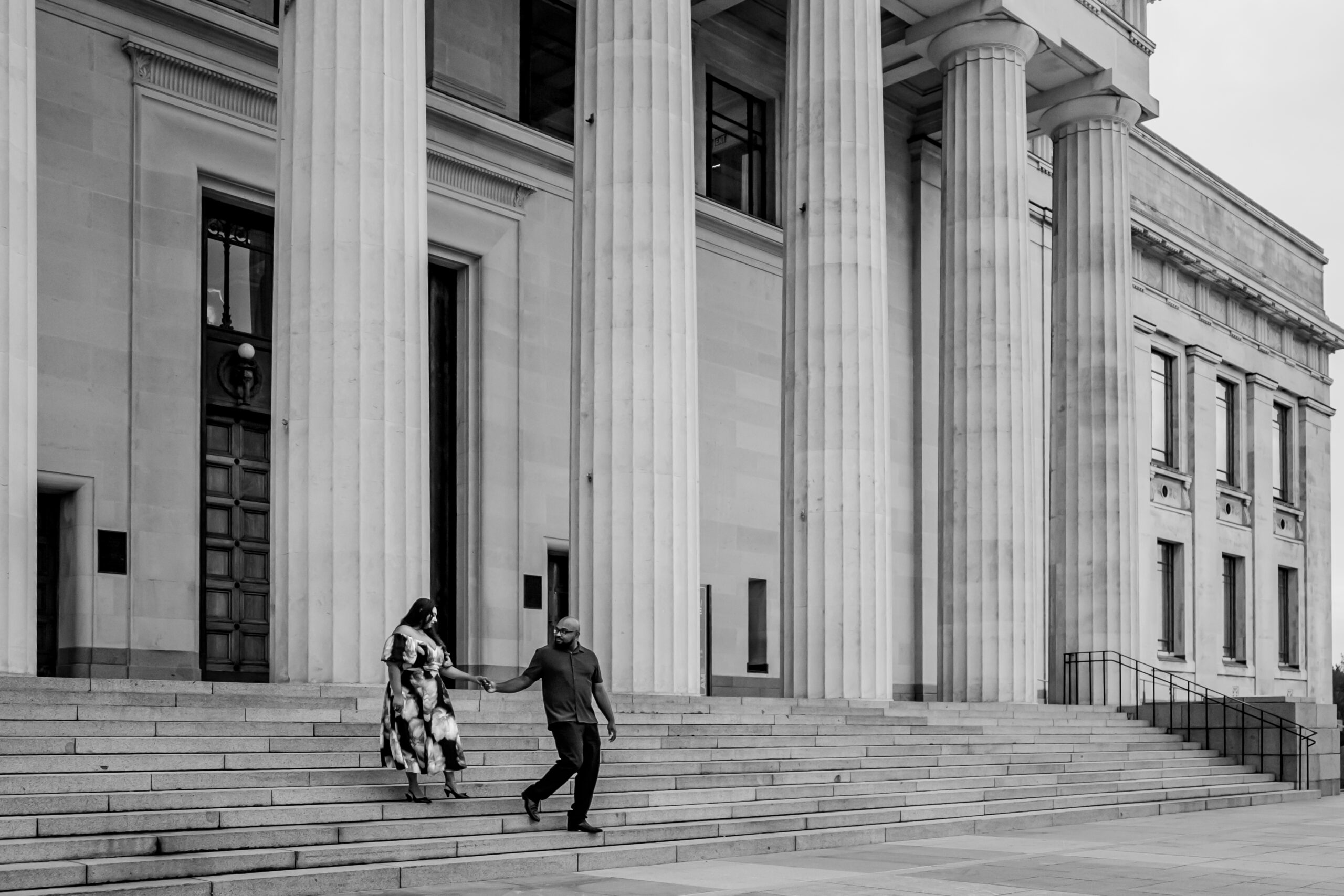 Surprise proposal at the Auckland Domain Rotunda with family present, captured on a cloudy day by Auckland proposal photographer Zanthe Vorsatz