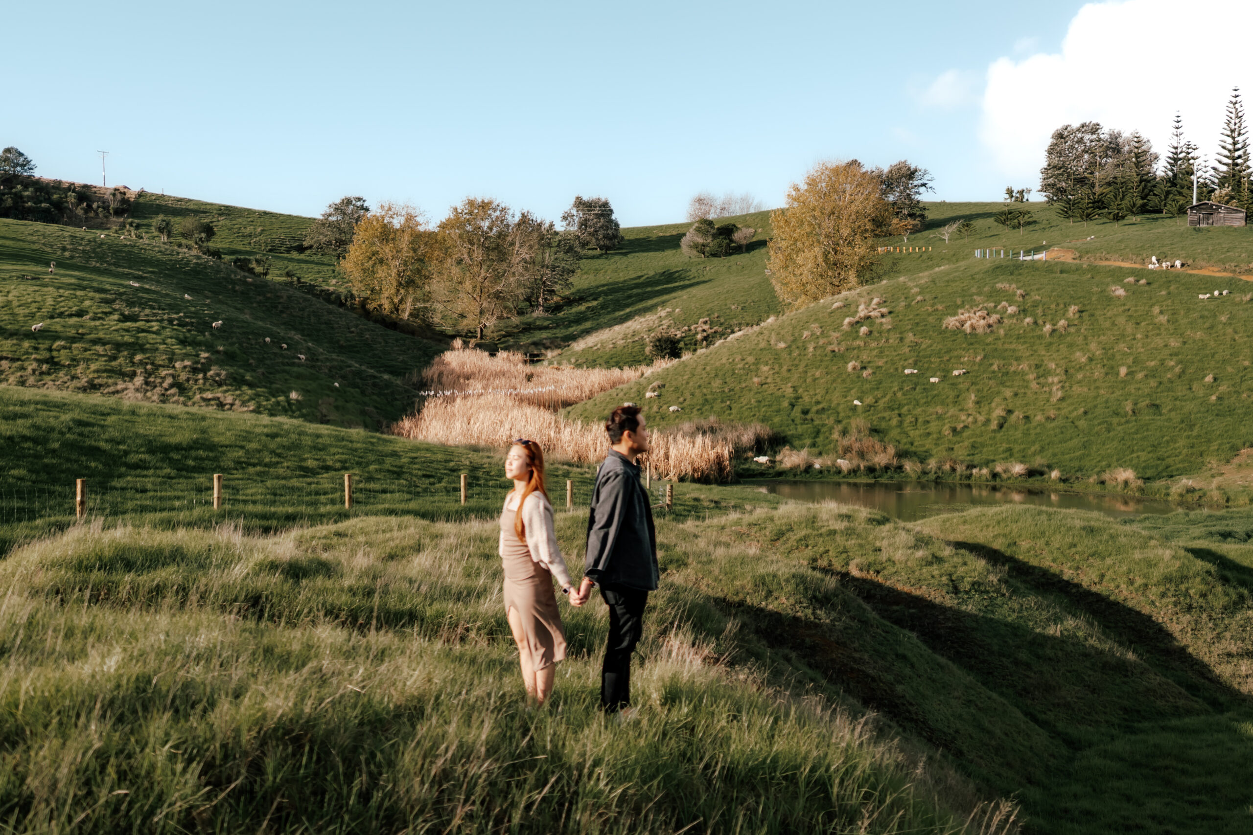 Thomas proposing to Jocelyn at Brick Bay surrounded by autumn leaves and trees