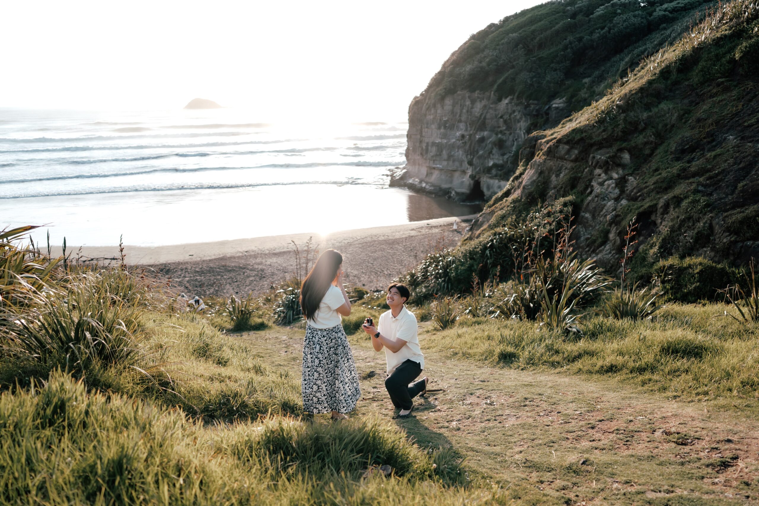 Andy proposing to Vivienne on the hill overlooking the ocean
